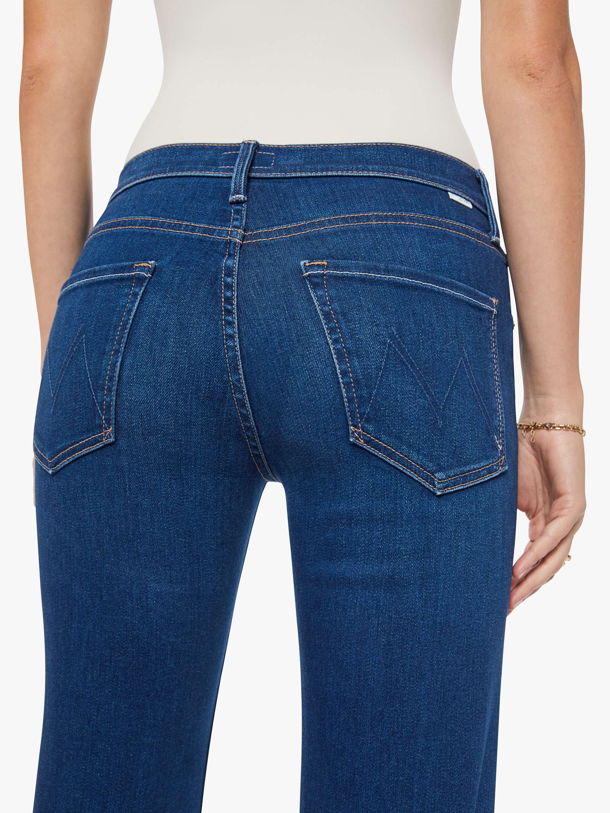 Blue jeans worn by a person on a white background