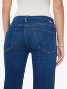 Blue jeans worn by a person on a white background