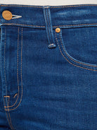 Close-up of blue denim jeans with stitching and button details.
