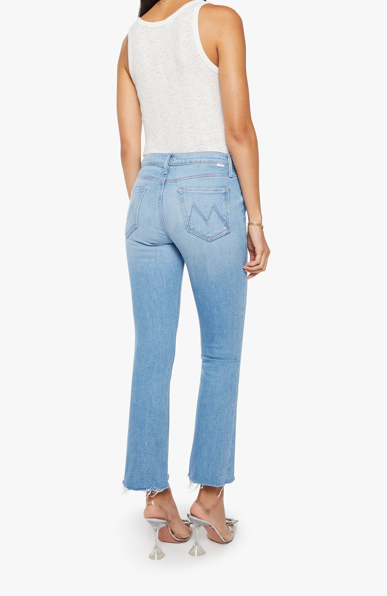 Light blue jeans worn by a person on a white background