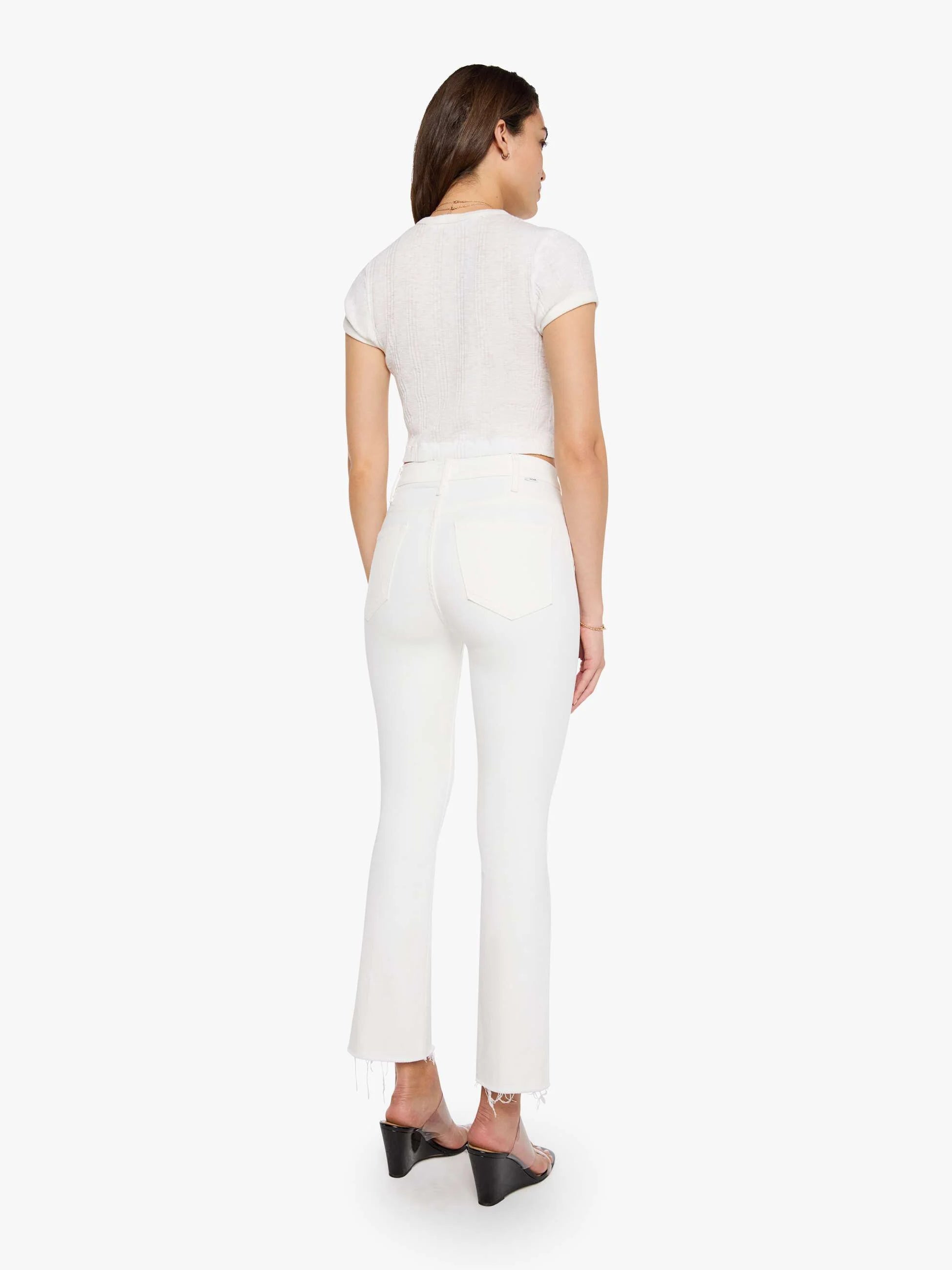 Woman wearing a white outfit on a white background
