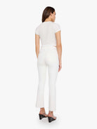 Woman wearing a white outfit on a white background