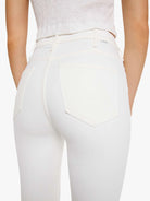 White pants worn by a person on a white background