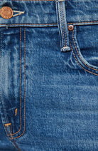 Close-up of blue denim fabric with stitching details