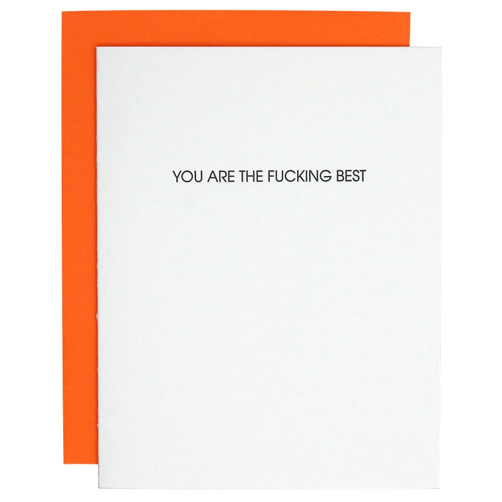 A white greeting card with the text 'YOU ARE THE FUCKING BEST' printed in black, shown with a bright orange envelope behind it on a white background.
