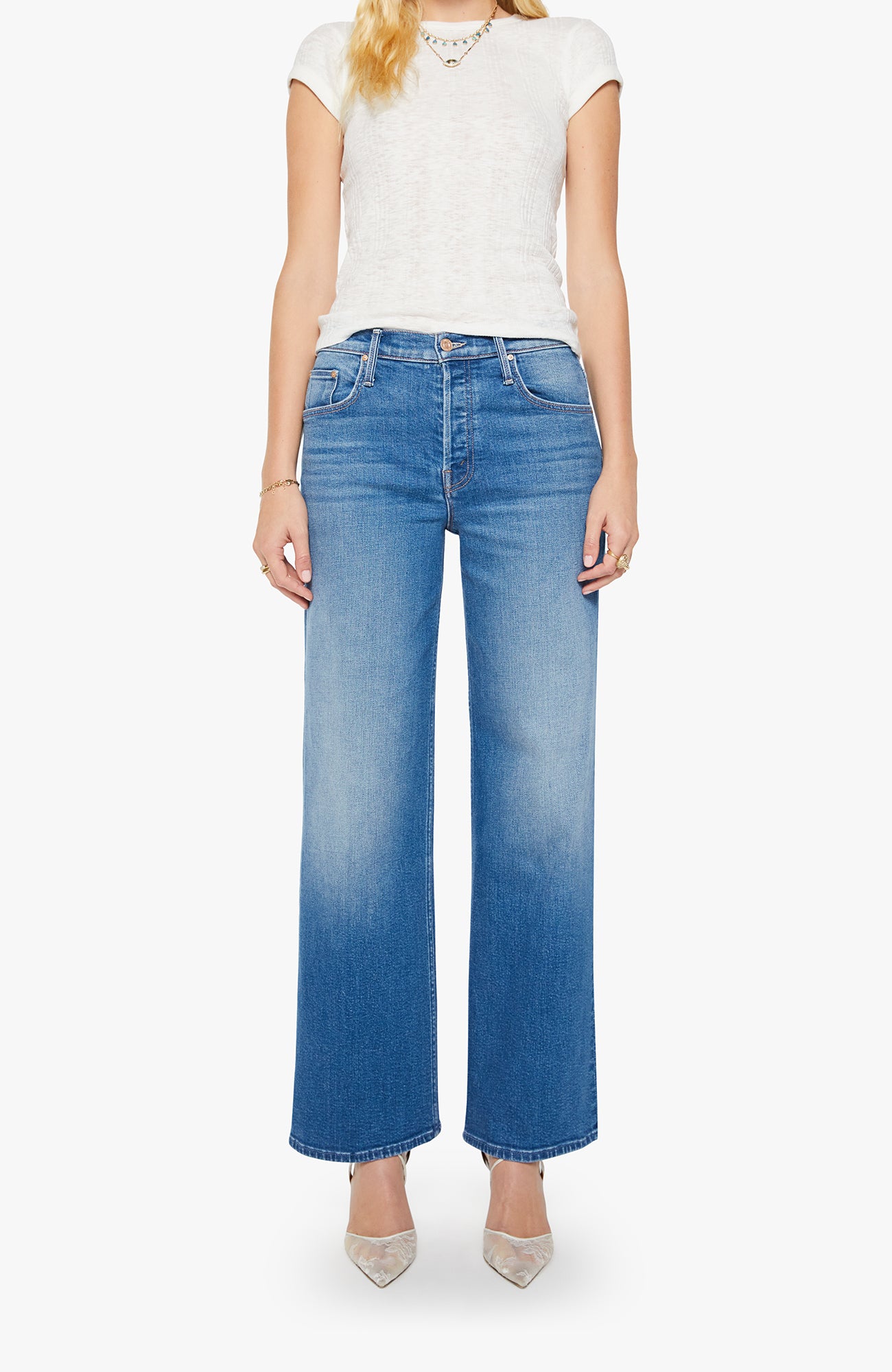Person wearing blue jeans and a white top on a white background