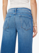 Blue jeans worn by a person on a white background