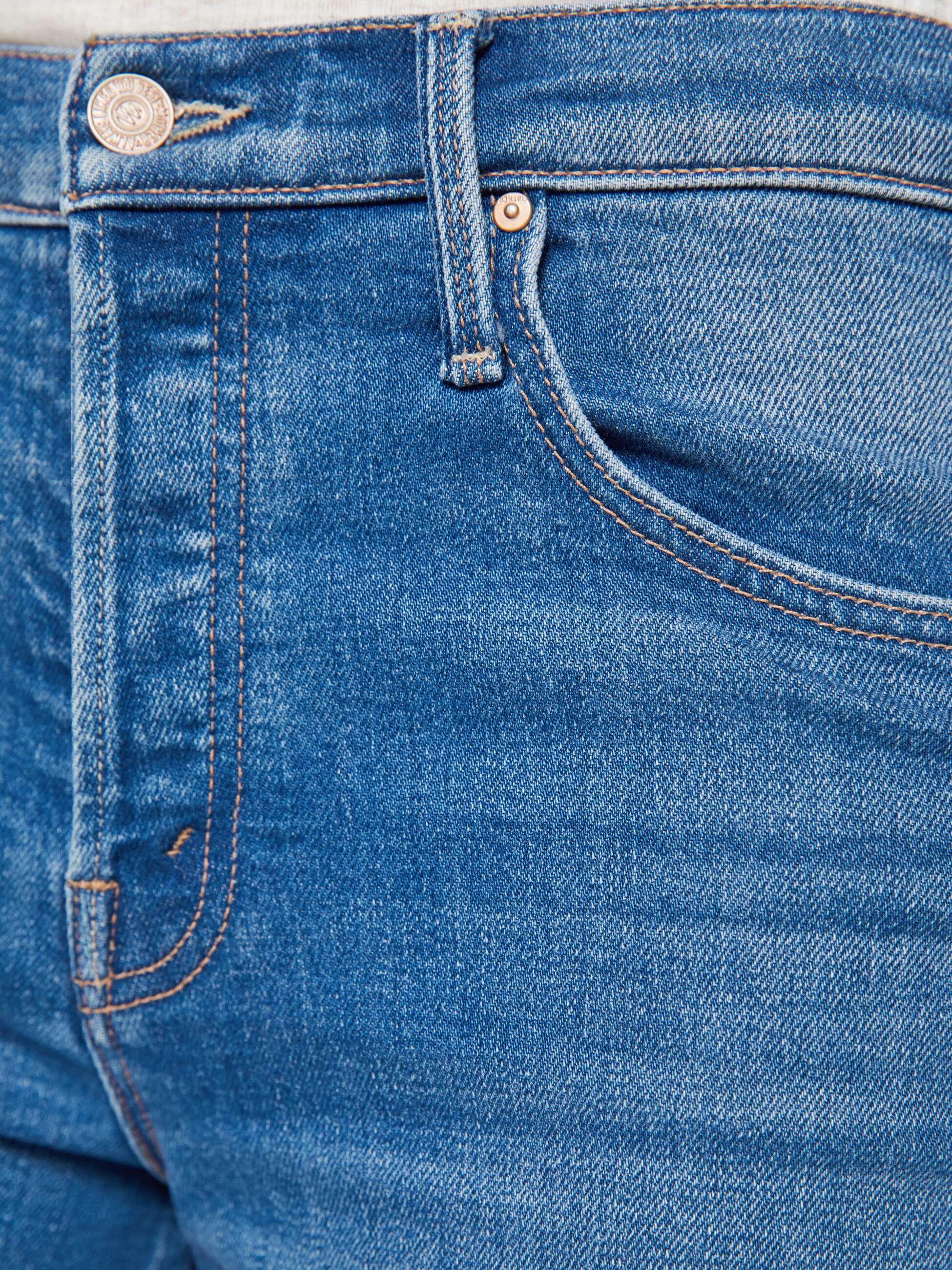 Close-up of blue denim jeans with stitching details