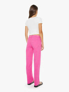 Person wearing bright pink pants and a white top on a white background