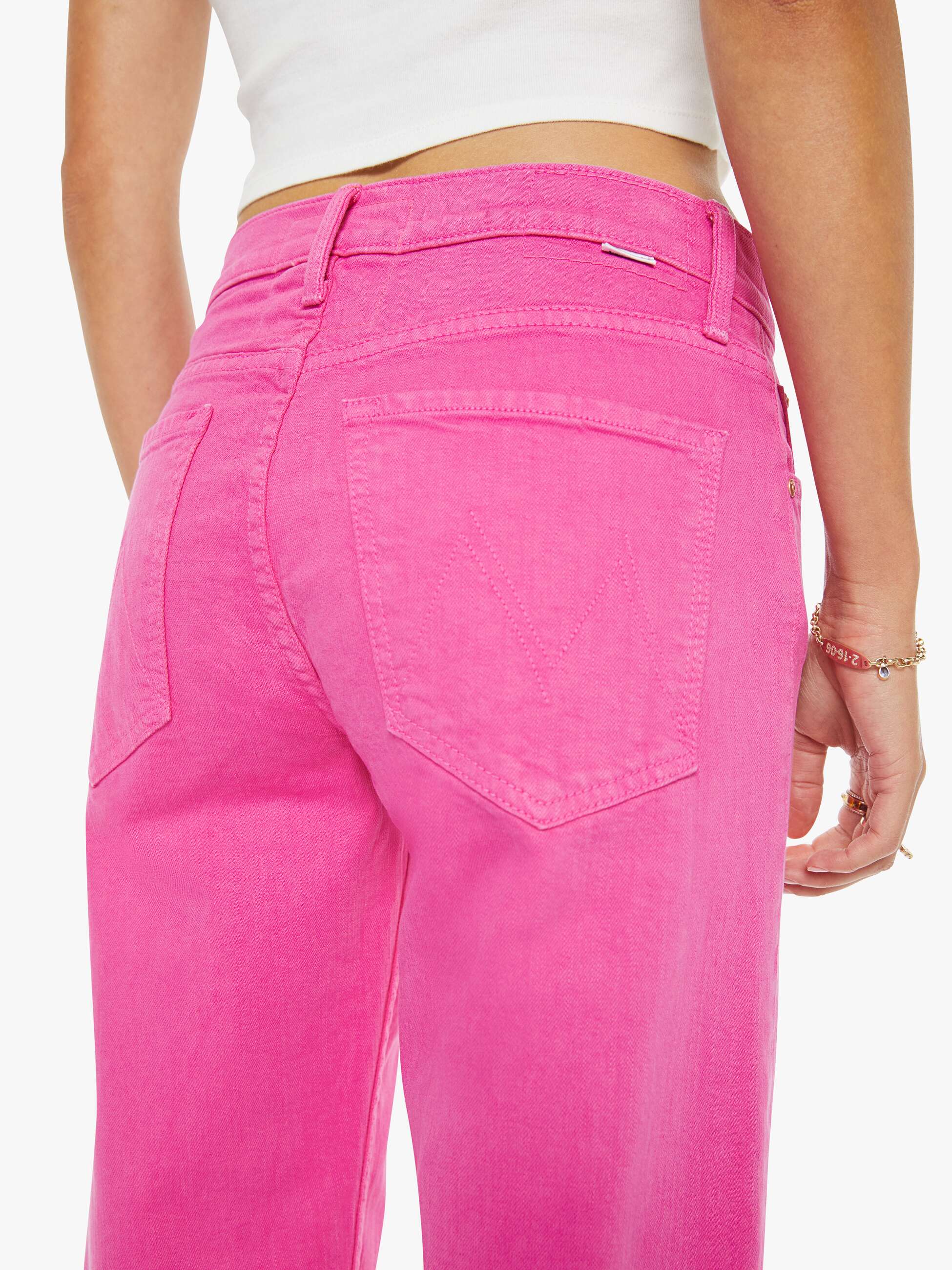 Person wearing bright pink pants on a white background