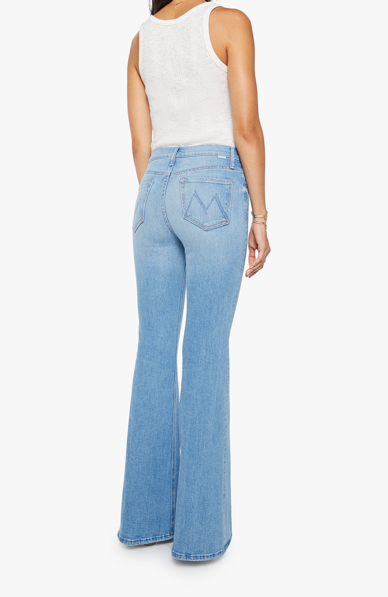 Light blue flared jeans worn by a person on a white background