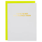 A white greeting card with gold foil text reading 'YOU'RE THE BEST BAD INFLUENCE I KNOW' and a bright yellow envelope behind it, shown on a white background.