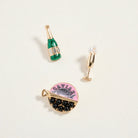 Three decorative earrings on a light beige background