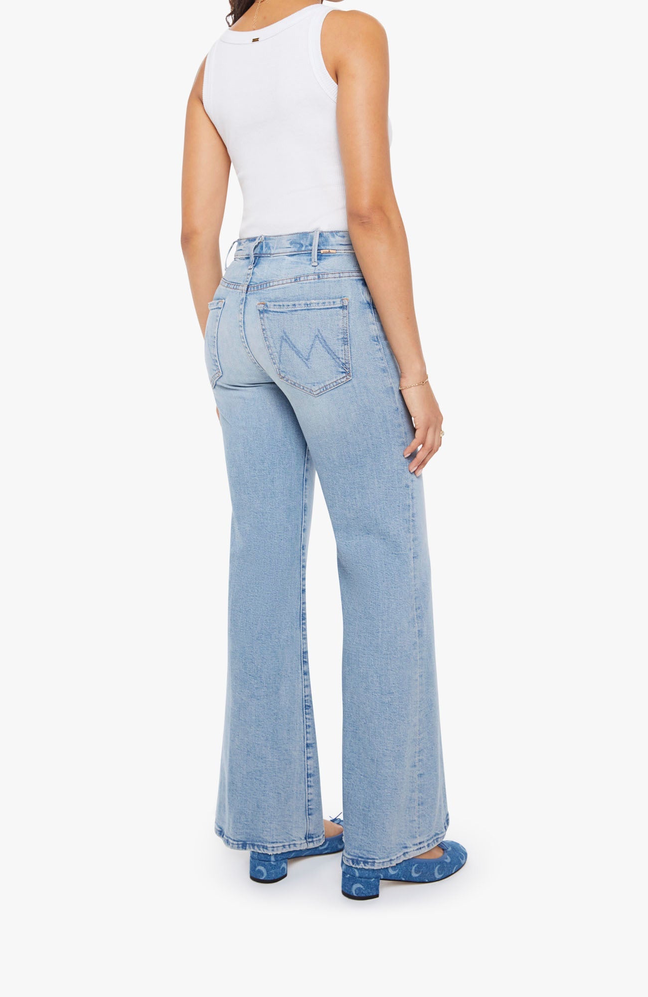 Light blue flared jeans worn by a person on a white background