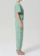 Person wearing a mint green outfit on a white background