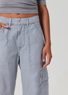 Gray cargo pants worn by a person on a plain background