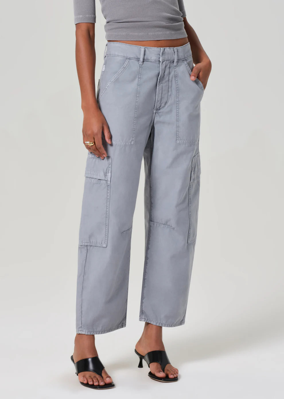 Gray cargo pants worn by a person on a plain background