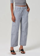 Gray cargo pants worn by a person on a plain background