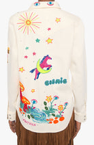 An off-white western-style shirt jacket with colorful embroidered designs on the back, including a unicorn, stars, mushrooms, flowers, and the words 'esmie' and 'MOTHER'.