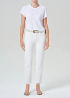 Person wearing a white t-shirt and white pants on a plain background