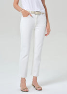 Person wearing white pants with a plain background