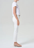 Person wearing a white t-shirt and pants on a plain background