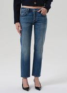 Person wearing blue jeans on a white background