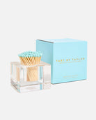 Matchbox with light blue matchcaps and clear holder next to a blue box labeled 'Tart by Taylor' on a white background.