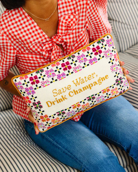 Person holding a pouch with 'Save Water, Drink Champagne' text