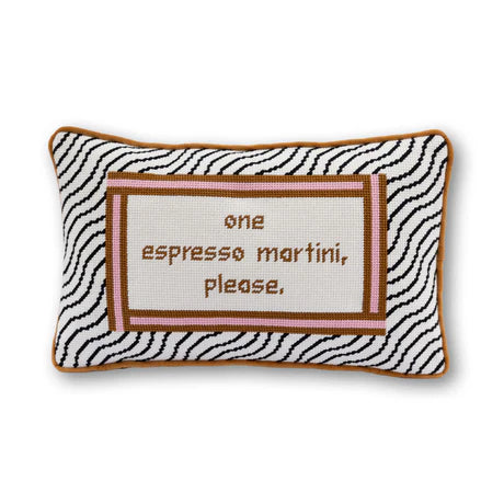 Decorative pillow with zebra pattern and text 'one espresso martini, please.' on a white background