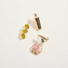 Three decorative charms on a light gray background