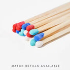 Several wooden matchsticks with colorful match heads in red, blue, light blue, and white, arranged on a white background with the text 'MATCH REFILLS AVAILABLE' below.