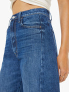 Close-up of blue jeans with a white background