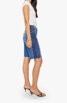Woman wearing blue denim shorts on a white background