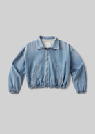 Light blue denim jacket on a gray background