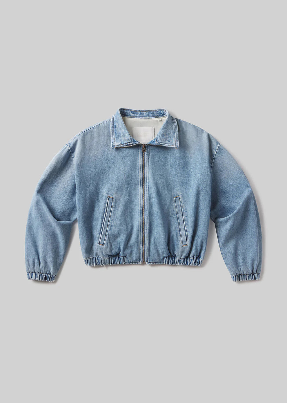 Light blue denim jacket on a gray background