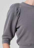 Gray sweatshirt worn by a person on a light gray background