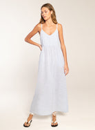 Woman wearing a light blue dress against a plain background