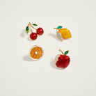 Four fruit-themed earrings on a light gray background
