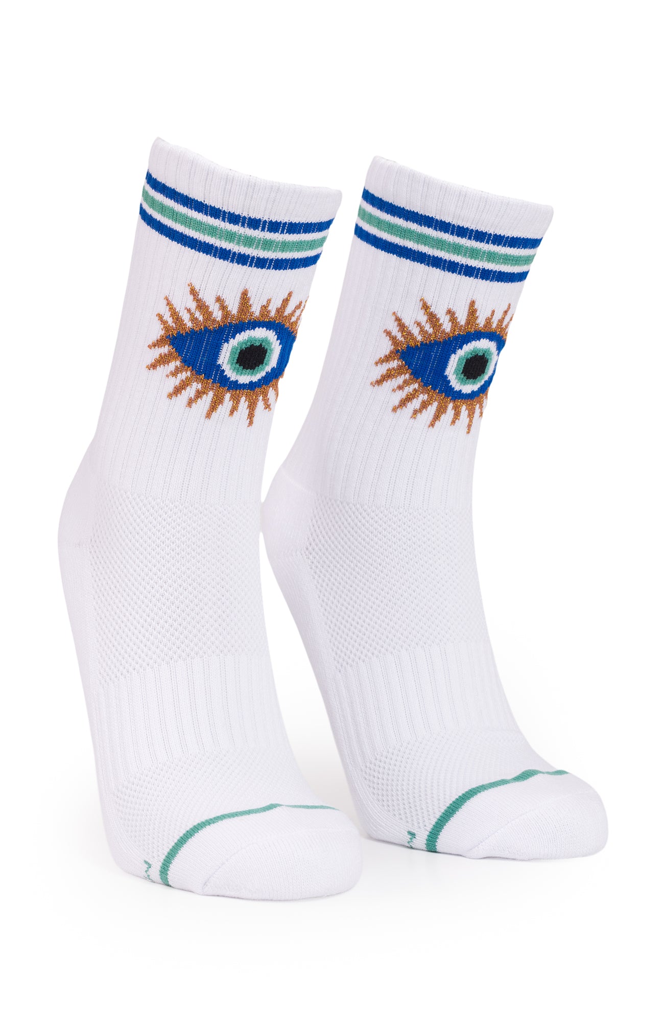 A pair of white crew socks featuring a stylized embroidered eye design in blue, green, and brown on the upper calf, with blue and green stripes at the ribbed cuff and a thin green line near the toe.