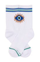 A pair of white crew socks featuring a central embroidered eye design with blue, green, and orange details, accented with blue and green stripes near the top and a green stripe near the toes.