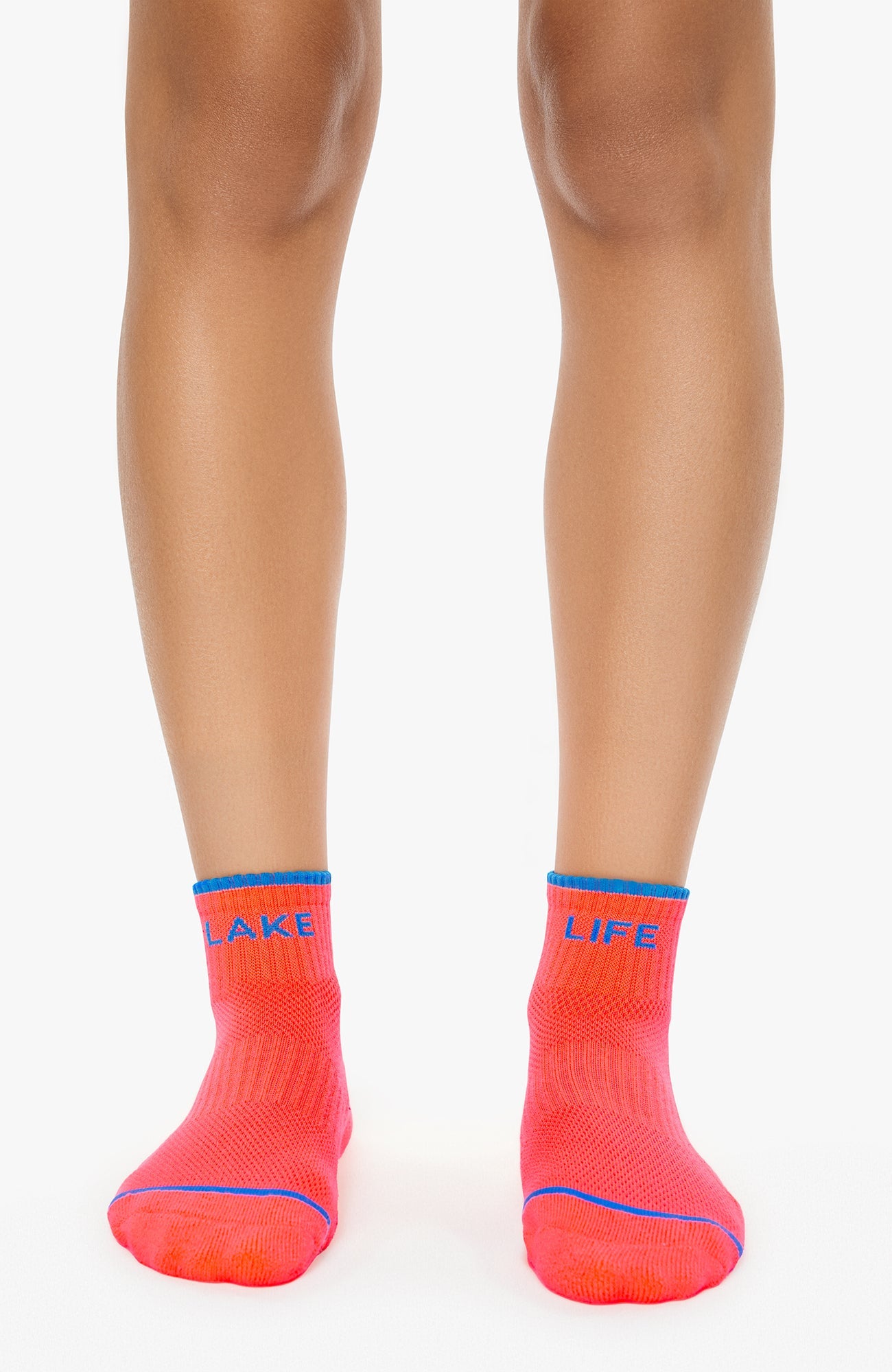 Person wearing bright red socks with 'Lake Life' text on a white background