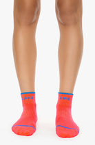 Person wearing bright red socks with 'Lake Life' text on a white background