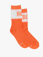Orange socks with white accents on a light gray background