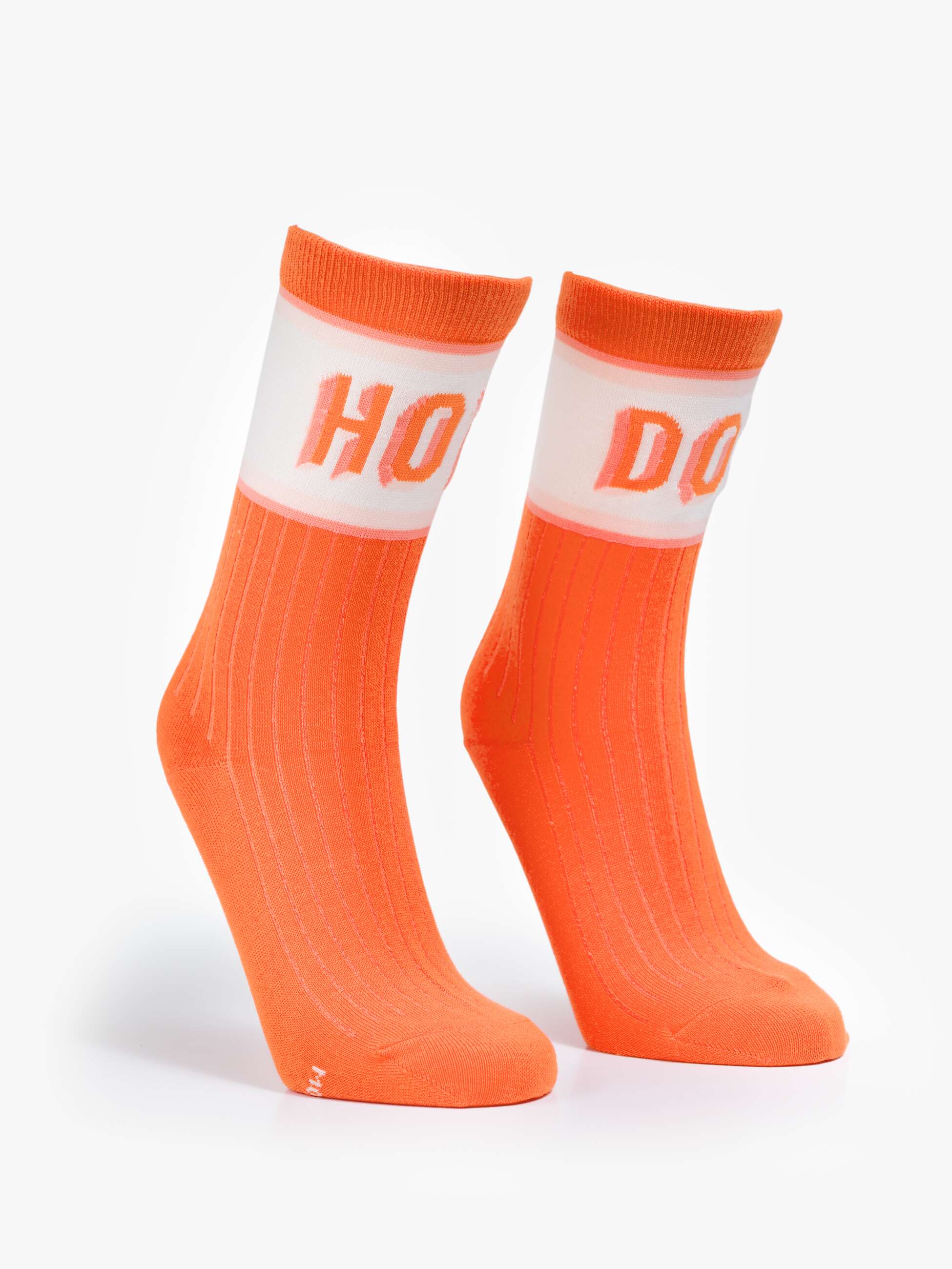 Orange socks with white accents on a light gray background