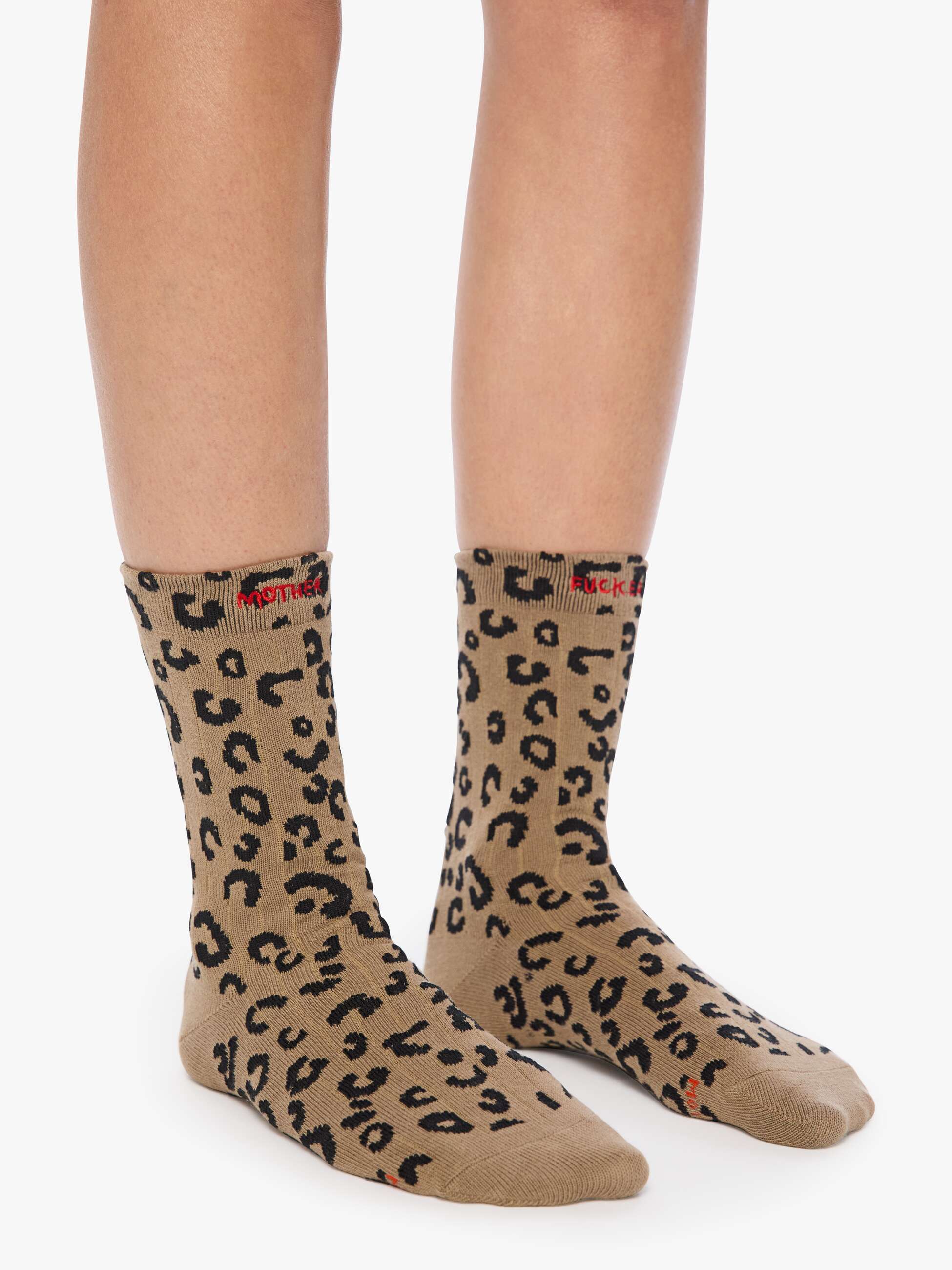 Leopard print socks worn by a person on a white background