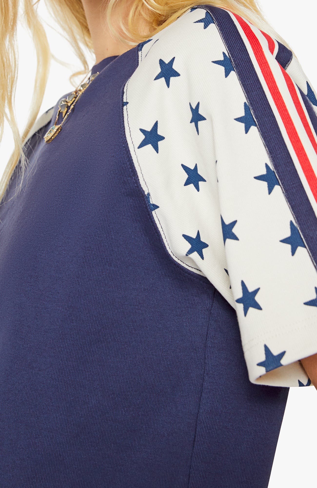 Navy dress with white sleeves featuring blue star patterns and red, white, and blue striped accents.