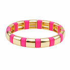 Gold bracelet with pink accents on a white background