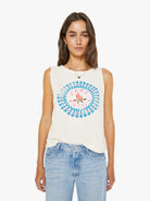 Woman wearing a sleeveless shirt with a colorful design on a white background