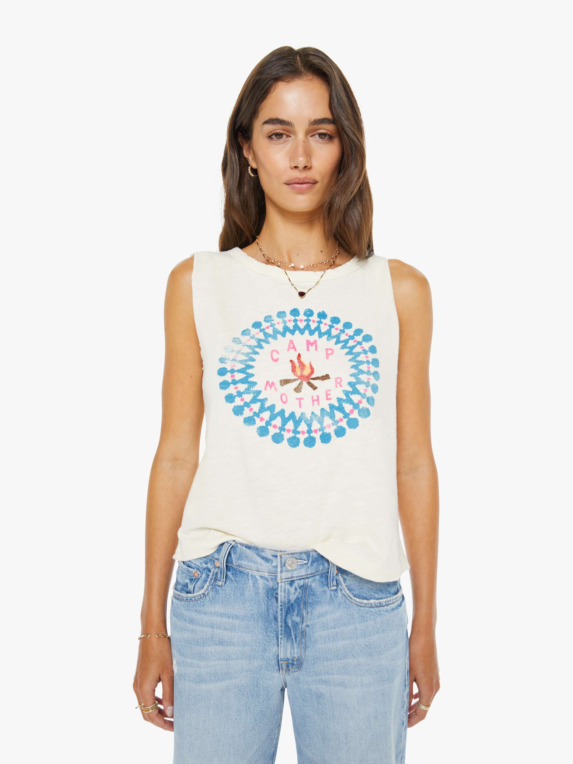 Woman wearing a sleeveless shirt with a colorful design on a white background